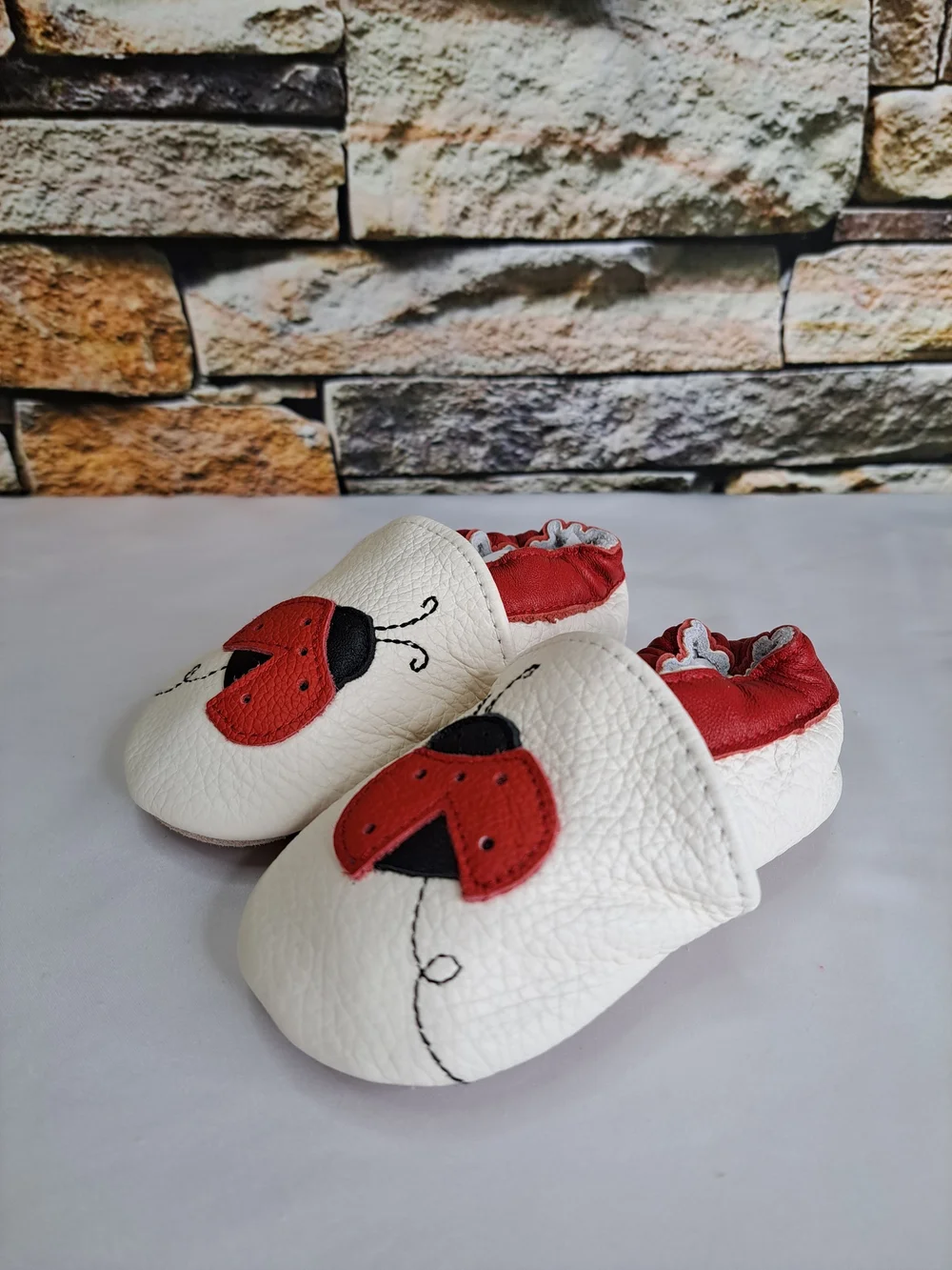 Baby White Leather Slip-On Shoes with Red Ladybug Detail
